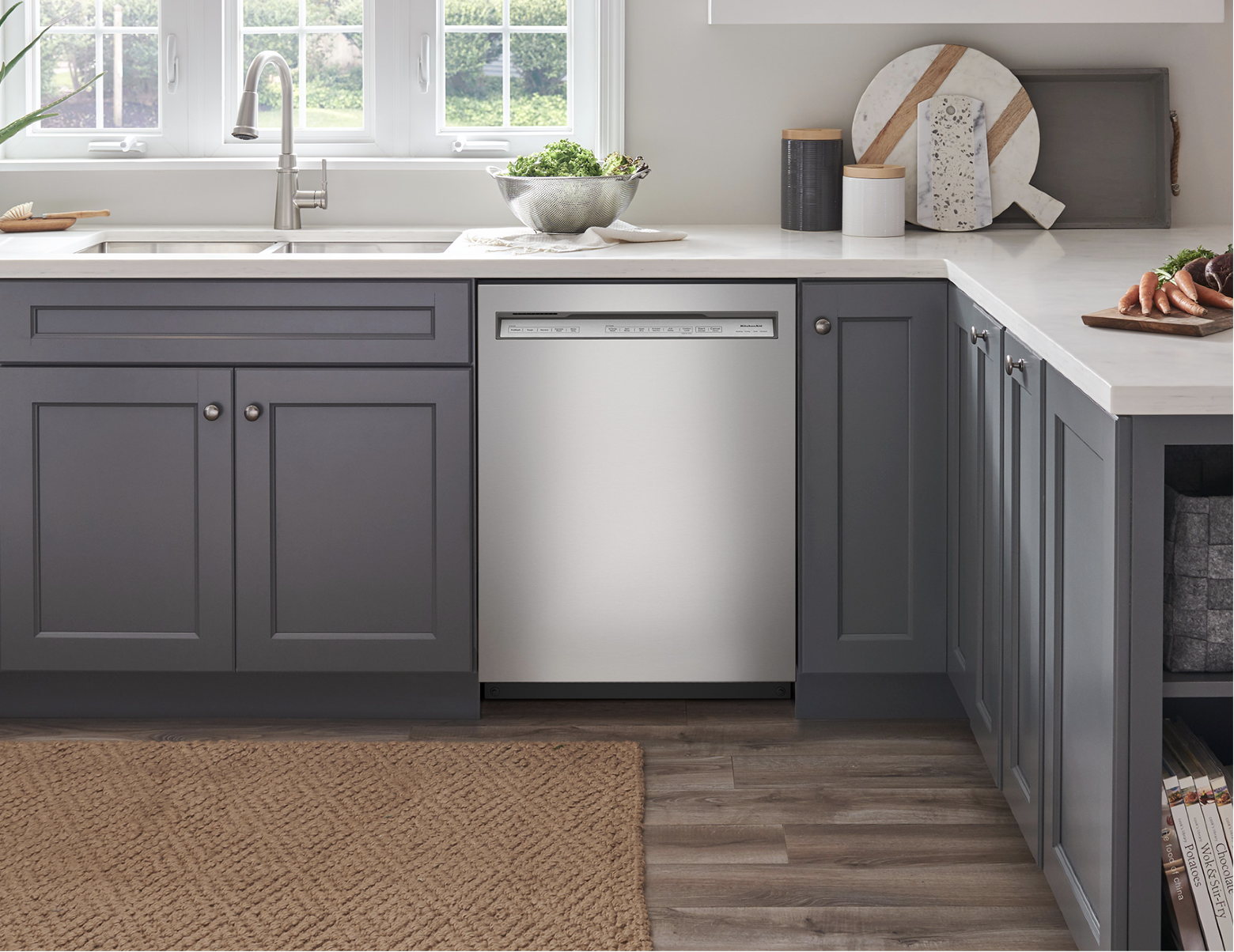 a built-in kitchenaid dishwasher in a kitchen with gray cabinets